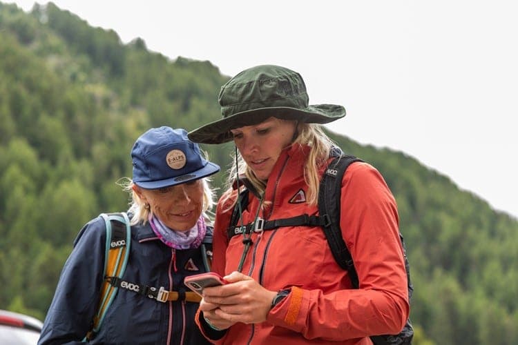 Mother and daughter checking GPS during their hike
