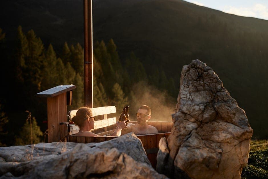 A post-ride dip in a hut tub with Alpine views is a must in our Haute Routes