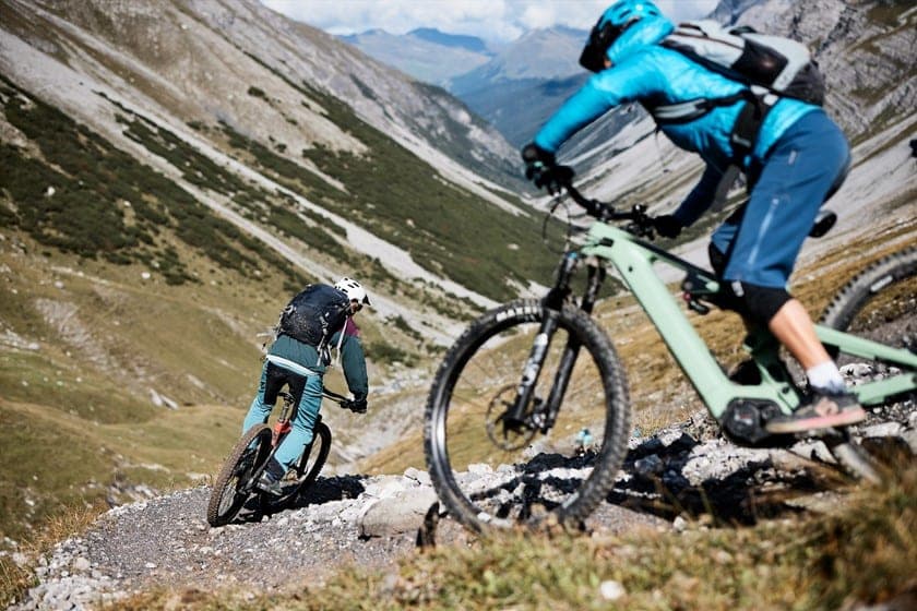 Two riders on a steep switchback