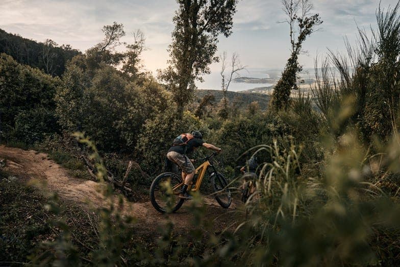 Riding down Piombino's lush mountains with a view of the sea