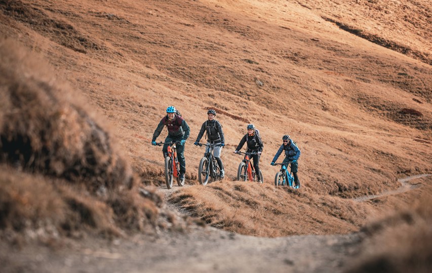 Happy riders on a perfectly smooth singletrack trail on the Haute Route